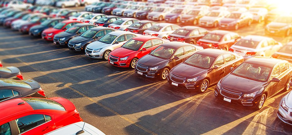 parking lot full of sedans in multiple colors